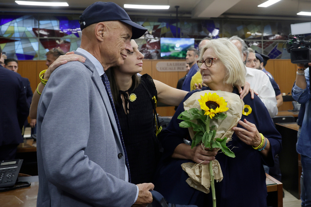 Paola Deffendi, Giulio Regeni's mother, right, her husband Claudio and their daughter Irene, center, embrace after the verdict of a Rome court which convicted three of four Egyptian security officials to 10 years in prison for the abduction and murder of Giulio in Cairo in 2016, in Rome, Monday, Sept. 28, 2026. (Cecilia Fabiano/LaPresse via AP)
