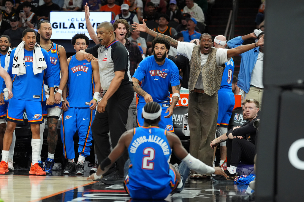 Oklahoma City Thunder guard Shai Gilgeous-Alexander (2) celebrates his score against the Phoenix Suns with teammates on the bench during the second half of Game 4 in a first-round NBA playoffs basketball series, Monday, April 27, 2026, in Phoenix. (AP Photo/Ross D. Franklin)