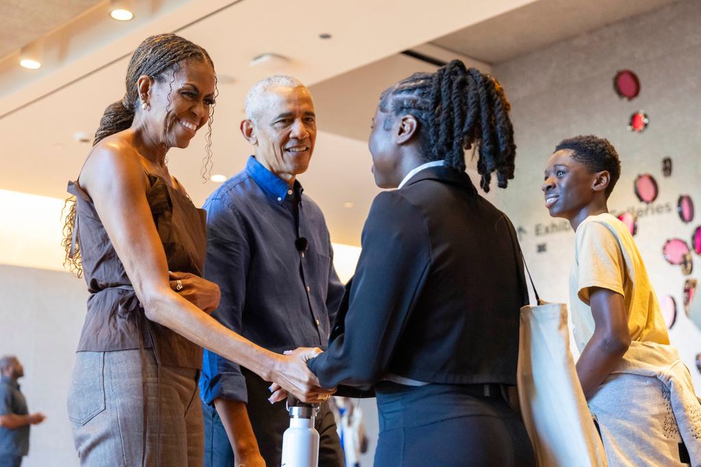 Former President Barack Obama and former first lady Michelle Obama greet community members in the Hope and Change lobby before they walk through the museum at the Obama Presidential Center in Chicago on Friday, June 19, 2026. (Eileen T. Meslar /Chicago Tribune via AP, Pool)