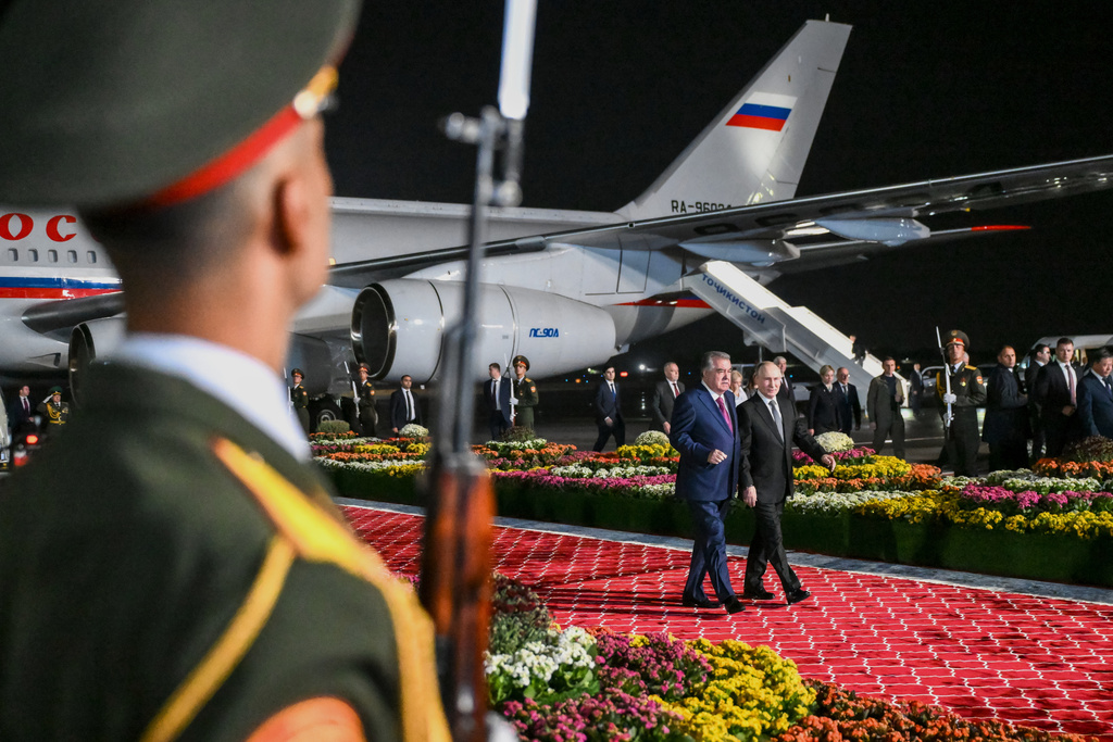 Russian President Vladimir Putin, right, is greeted by Tajik President Emomali Rahmon upon his arrival in Dushanbe, Tajikistan, Wednesday, Oct. 8, 2025. (Grigory Sysoyev, Sputnik, Kremlin Pool Photo via AP)