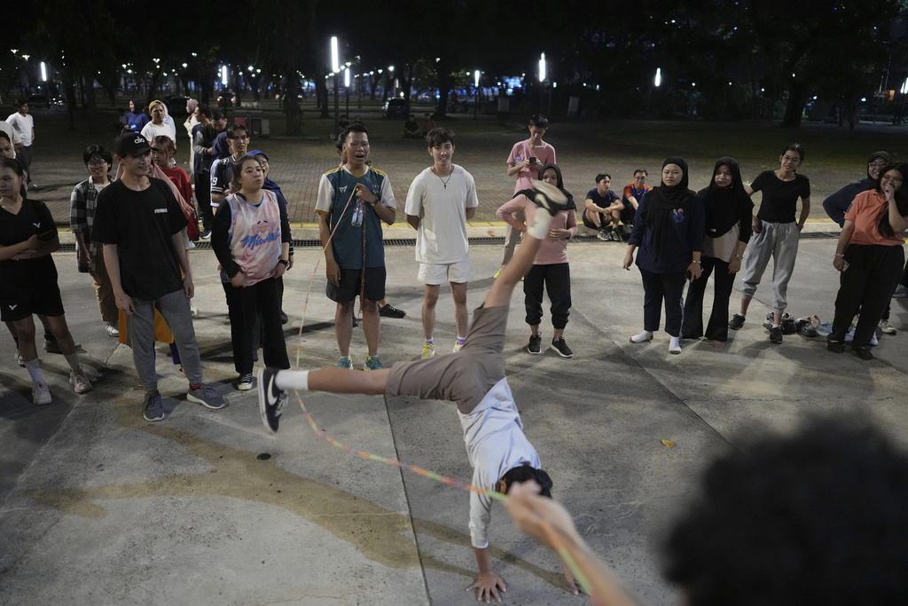 People play jump rope during a community playing gathering in Jakarta, Indonesia, Friday, July 11, 2025. (AP Photo/Dita Alangkara)