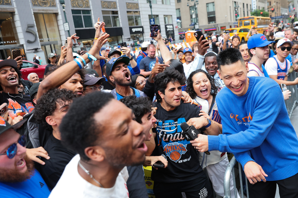Former New York Knicks player Jeremy Lin, right, interviews Knicks fans outside of Madison Square Garden ahead of Game 4 of the NBA Finals between the Knicks and San Antonio Spurs, Wednesday, June 10, 2026, in New York. (AP Photo/Heather Khalifa)
