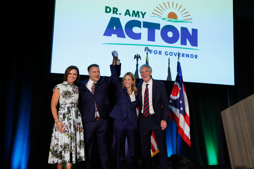 From left, Alana Pepper, former state Democratic Chair David Pepper, Democratic gubernatorial candidate Dr. Amy Acton and Eric Acton celebrate at a primary election night campaign event after winning the party's nomination for governor in Columbus, Ohio, Tuesday, May 5, 2026. (AP Photo/Jay LaPrete)
