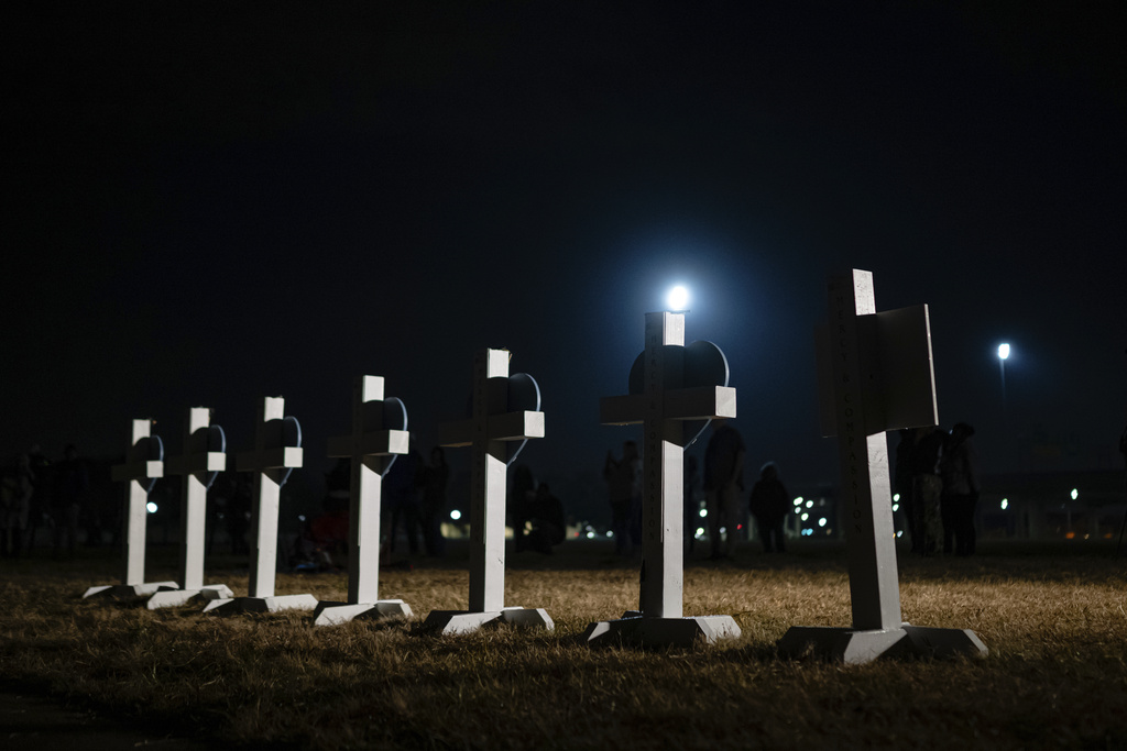Crosses stand during a vigil for those killed and missing after a UPS plane crashed, at the Great Lawn, Friday, Nov. 7, 2025, in Louisville, Ky. (AP Photo/Jon Cherry)