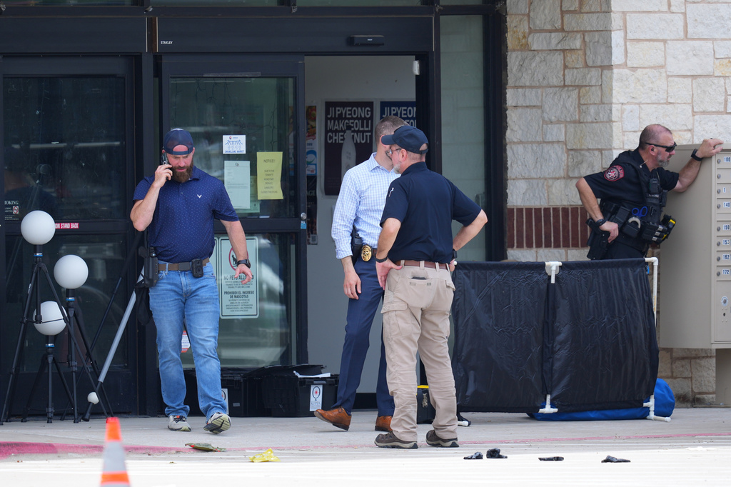 Officials respond to the scene of a shooting Tuesday, May 5, 2026, at K Towne Plaza in Carrollton, Texas. (AP Photo/Julio Cortez)