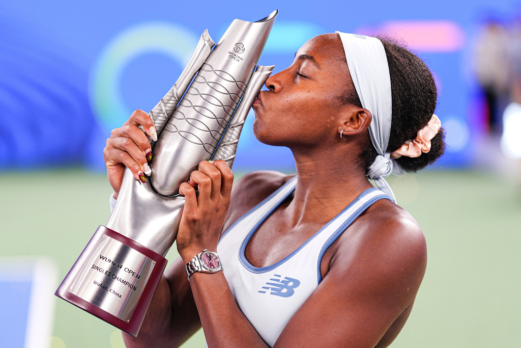 Coco Gauff of the United States celebrates with her trophy after defeating her compatriot Jessica Pegula in the women's singles final at the WTA Wuhan Open in Wuhan in central China's Hubei province Sunday, Oct. 12, 2025. (Chinatopix Via AP) CHINA OUT