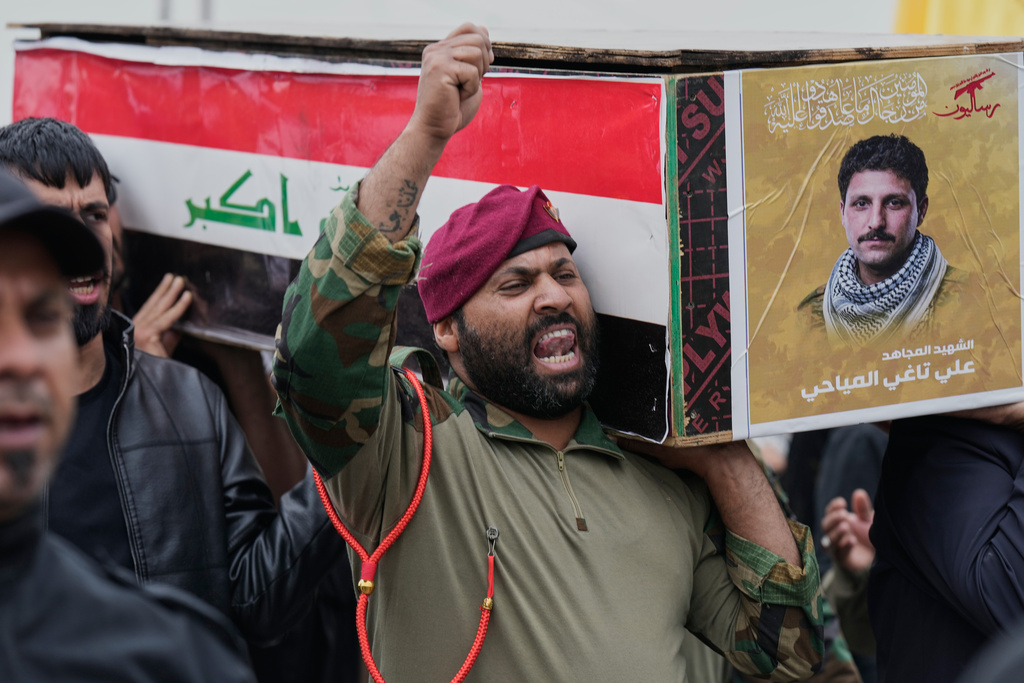 Members from the Popular Mobilization Forces attend the funeral of fighters who were killed, according to their statement, in a U.S.-Israel airstrike, in Baghdad, Iraq, Thursday, March 19, 2026. (AP Photo/Hadi Mizban)