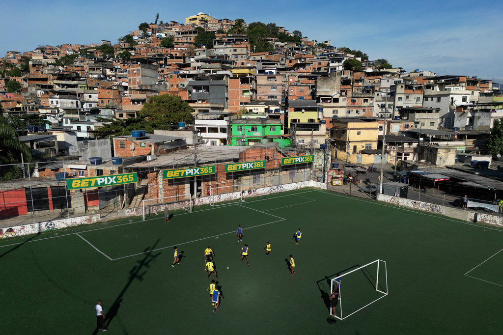 FILE - Betting company advertisements adorn a soccer field during a training program in the Complexo do Alemao favela, in Rio de Janeiro, Brazil, July 1, 2023. (AP Photo/Bruna Prado, File)