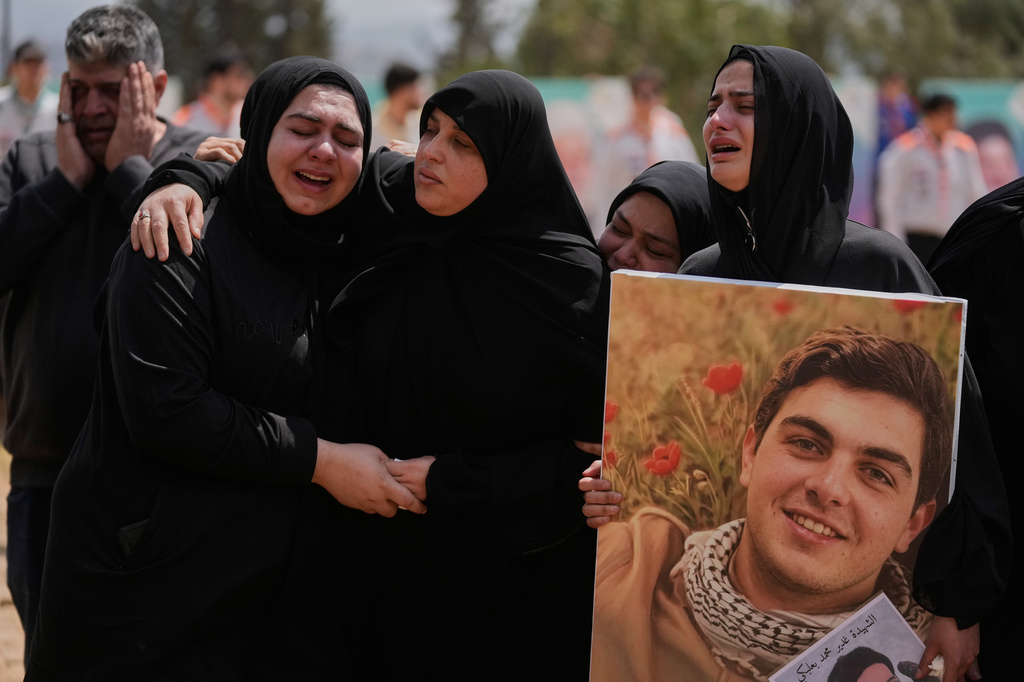 Mourners react during a mass funeral for Hezbollah fighters and civilians who were killed in the war between Hezbollah and Israel, in Bazouriyeh village, south Lebanon, Monday, April 20, 2026. (AP Photo/Mohammed Zaatari)