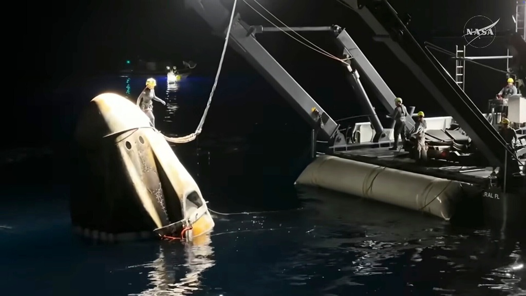 This screengrab from video provided by NASA shows the NASA's SpaceX Crew-11 capsule being taken into the recovery vessel after crew members re entered the earth in a middle-of-the-night splashdown near San Diego, Calif., Thursday, Jan. 15, 2026. (NASA via AP)