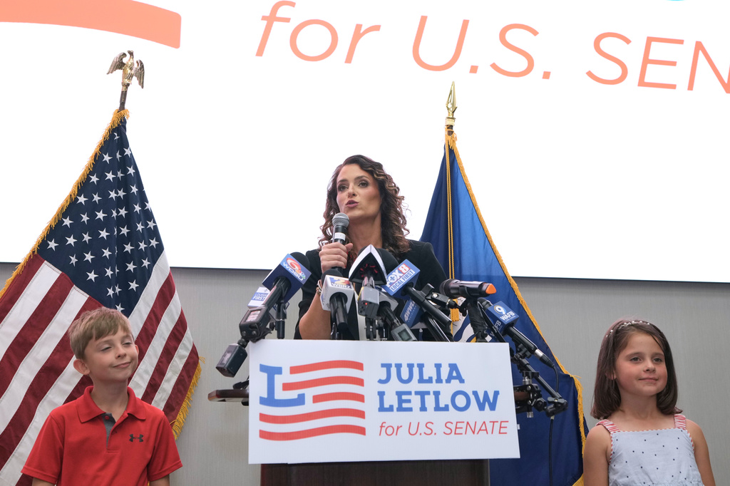 U.S. Senate candidate Rep. Julia Letlow, R-La., speaks to supporters alongside her two children, Jeremiah and Jacqueline, during an election night watch party Saturday, May 16, 2026, in Baton Rouge, La. (AP Photo/Matthew Hinton)