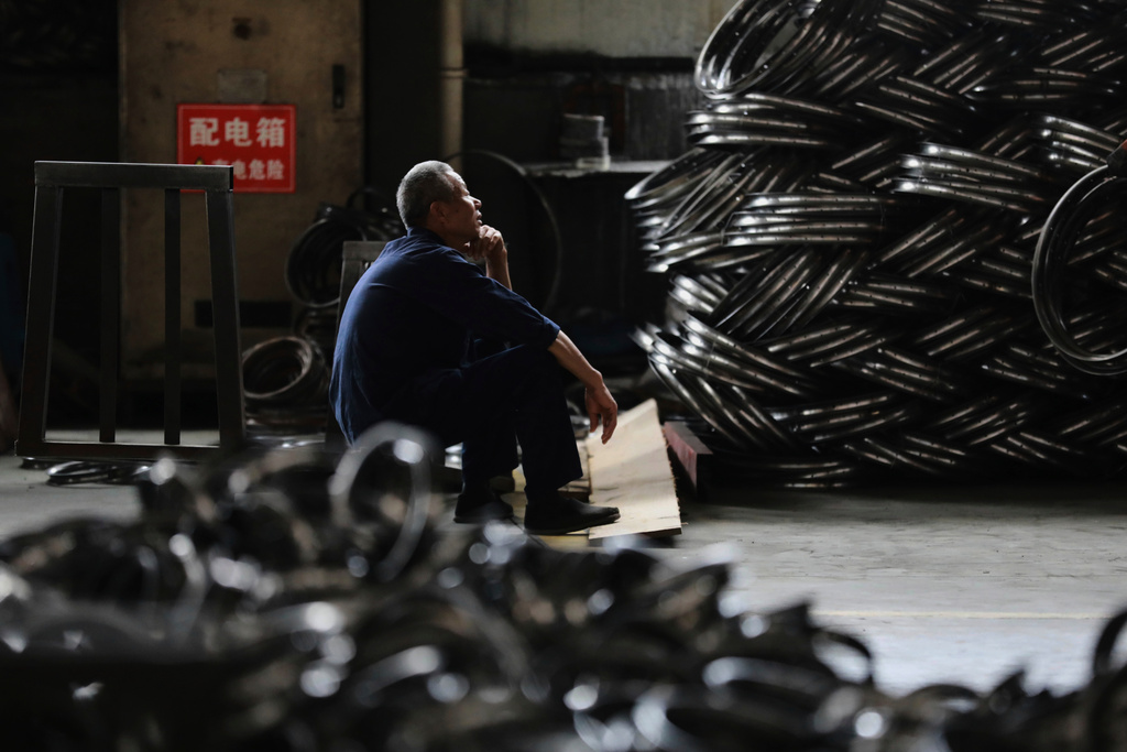 FILE - A worker takes a rest at a factory making steel bike rims for export to U.S., in Hangzhou in east China's Zhejiang province, on Friday, April 11, 2025. (Chinatopix Via AP, File)