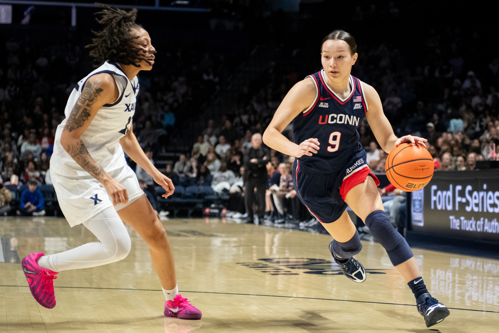 UConn guard Kayleigh Heckel (9) drives toward the basket during the second quarter of an NCAA college basketball game against Xavier, Sunday, Nov. 30, 2025, in Cincinnati. (AP Photo/Tanner Pearson)