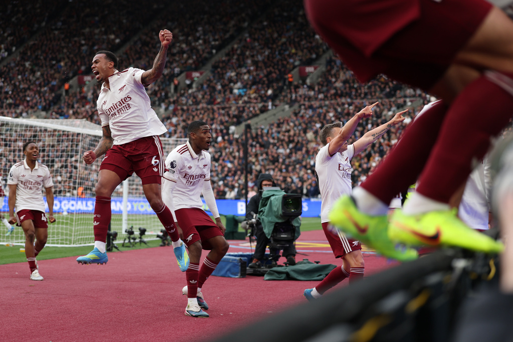 Arsenal players celebrate after scoring during the Premier League soccer match between West Ham and Arsenal in London, Sunday, May 10, 2026. (AP Photo/Ian Walton)