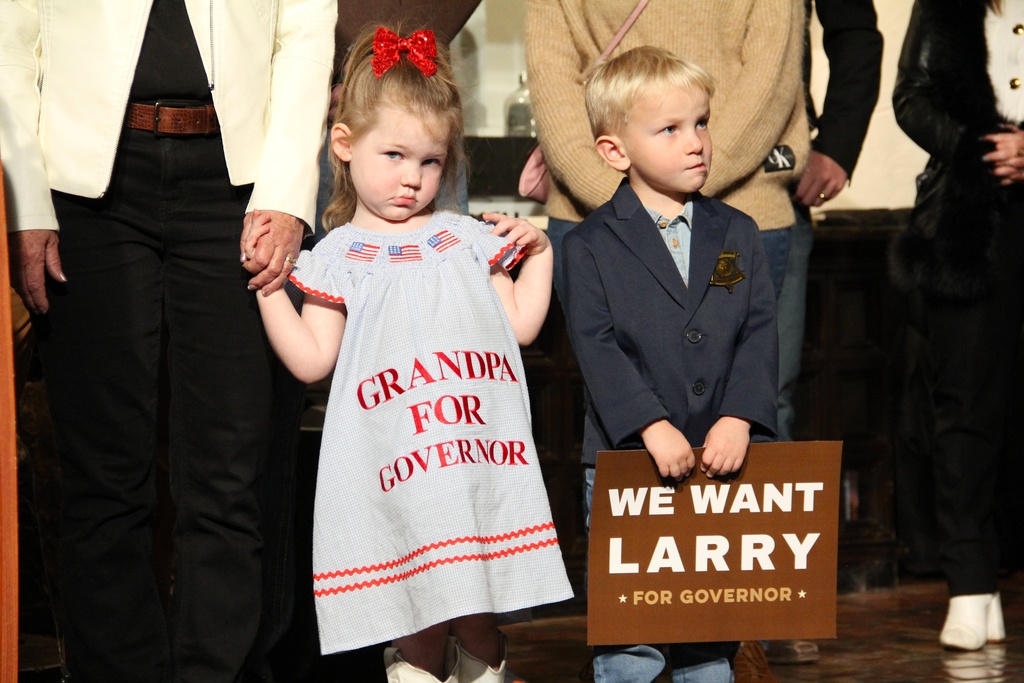 Gov. Larry Rhoden's grandchildren look on as he announces his run for a full term at the Hotel Alex Johnson, Tuesday, Nov. 18, 2025, in Rapid City, S.D. (Shalom Baer Gee/Rapid City Journal via AP)