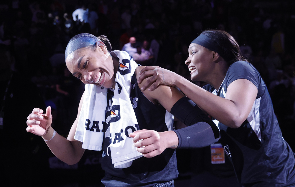 Las Vegas Aces center A'ja Wilson, left, and forward NaLyssa Smith, right, celebrate after their team defeated the Connecticut Sun in a WNBA basketball game Sunday, Aug. 10, 2025, in Las Vegas. (Steve Marcus/Las Vegas Sun via AP)