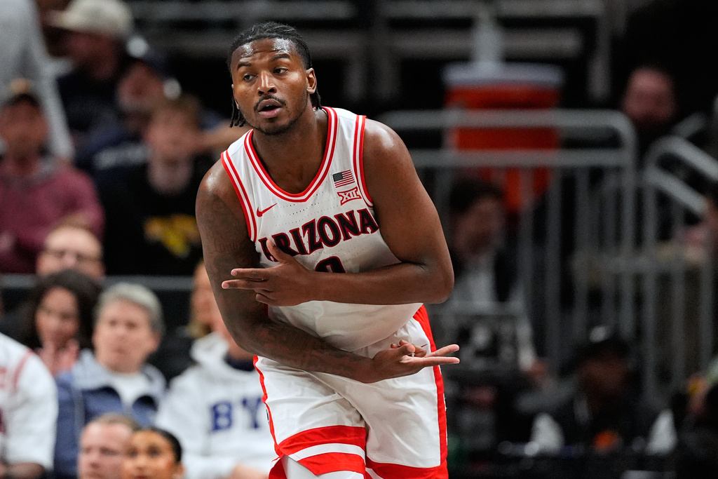 Arizona's Jaden Bradley celebrates after making a 3-point basket during the first half of an NCAA college basketball game against Houston in the championship of the Big 12 Conference tournament Saturday, March 14, 2026, in Kansas City, Mo. (AP Photo/Charlie Riedel)