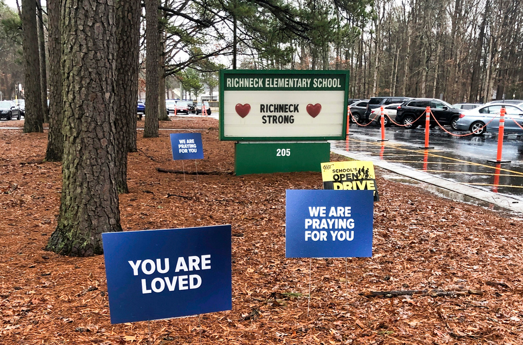 FILE - Signs stand outside Richneck Elementary School in Newport News, Va., Jan. 25, 2023. (AP Photo/Denise Lavoie, File)