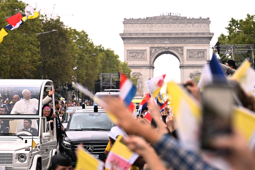 Pope Leo XIV waves to the crowd on the Champs Elysees avenue before a mass at the Place de la Concorde in Paris, Saturday, Sept. 26, 2026. (AP Photo/Emma Da Silva)