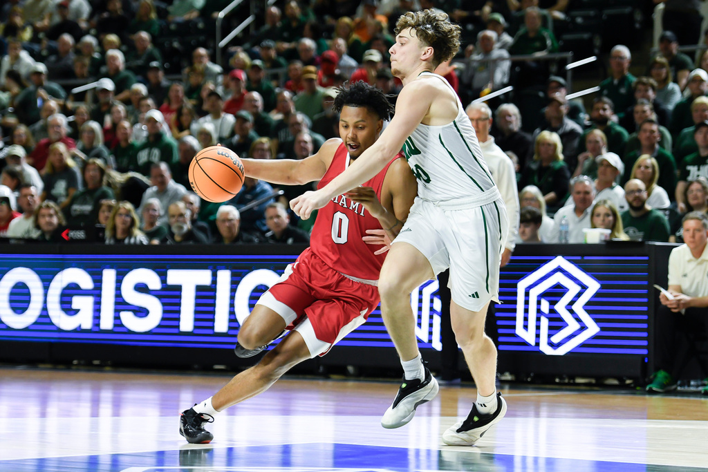 Miami (Ohio) wing Eian Elmer (0) drives past Ohio forward Aidan Hadaway (10) during the first half of an NCAA college basketball game, Friday, March 6, 2026, in Athens, Ohio. (AP Photo/HG Biggs)