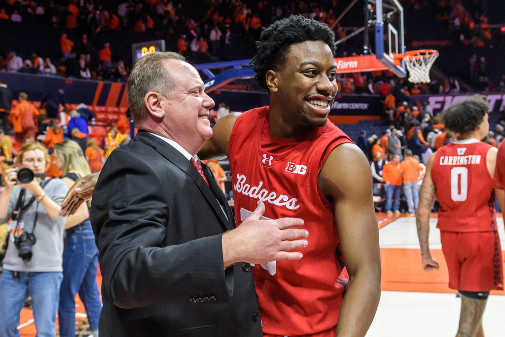 Wisconsin head coach Greg Gard celebrates with John Blackwell after an NCAA college basketball game against Illinois Tuesday, Feb. 10, 2026, in Champaign, Ill. (AP Photo/Craig Pessman)