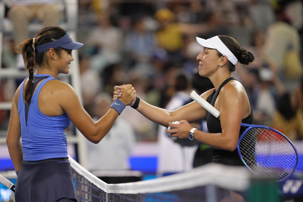 Jessica Pegula, of the United States shakes hands with Emma Raducanu, of Britain after the women's singles match for the China Open tennis tournament, in Beijing, Monday, Sept. 29, 2025. (AP Photo/Andy Wong)