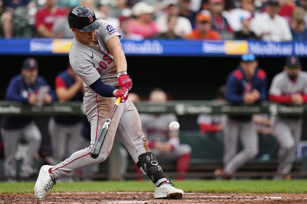 Boston Red Sox designated hitter Rob Refsnyder hits a home run during the fourth inning of a baseball game against the Baltimore Orioles, Thursday, Aug. 28, 2025, in Baltimore. (AP Photo/Stephanie Scarbrough)