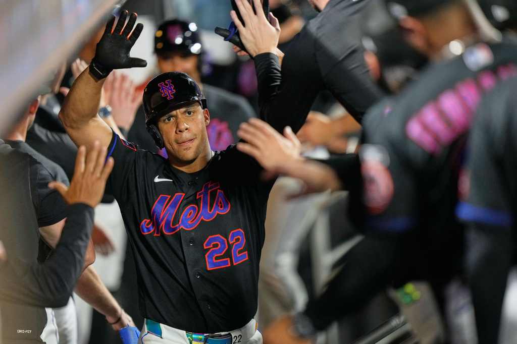 New York Mets' Juan Soto celebrates his three-run home run in the dugout during the sixth inning of a baseball game against the Philadelphia Phillies, Friday, Sept. 18, 2026, in New York. (AP Photo/Seth Wenig)