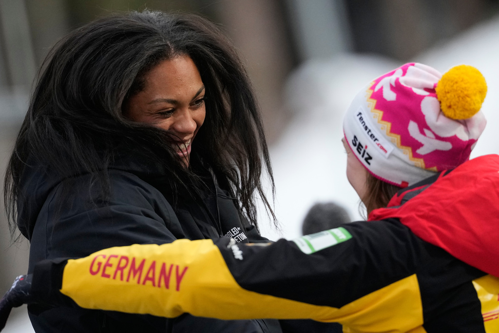 Winner Kaysha Love of the United States, left, celebrates with second placed Laura Nolte of Germany during the women's monobob race at the Bobsleigh World Cup in Innsbruck, Austria, Saturday, Nov. 29, 2025. (AP Photo/Matthias Schrader)
