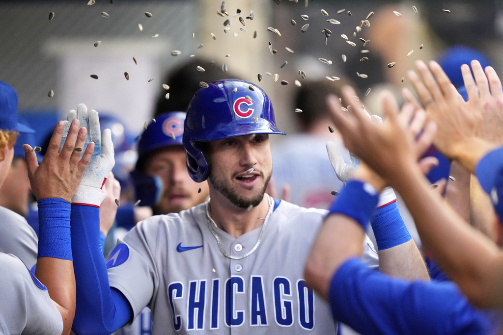 Chicago Cubs' Kyle Tucker is congratulated by teammates in the dugout after hitting a two-run home run during the third inning of a baseball game against the Los Angeles Angels, Saturday, Aug. 23, 2025, in Anaheim, Calif. (AP Photo/Mark J. Terrill)