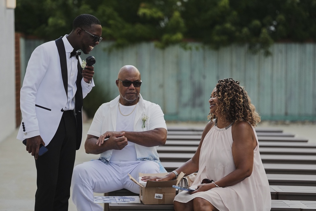 Tyler Jones, left, chats with family members before his wedding Saturday, Aug. 23, 2025, in Newtown, Ohio. (AP Photo/Joshua A. Bickel)