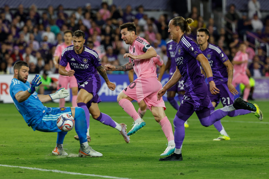 Inter Miami CF forward Lionel Messi, center, is surrounded by Orlando City SC players as he tries to score a goal during the first half of an MLS soccer match, Sunday, March 1, 2026, in Orlando, Fla. (AP Photo/Kevin Kolczynski)