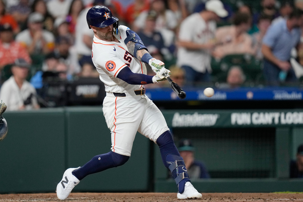 Houston Astros' Christian Walker hits a RBI double against the Seattle Mariners during the third inning of a baseball game Tuesday, May 12, 2026, in Houston. (AP Photo/David J. Phillip)