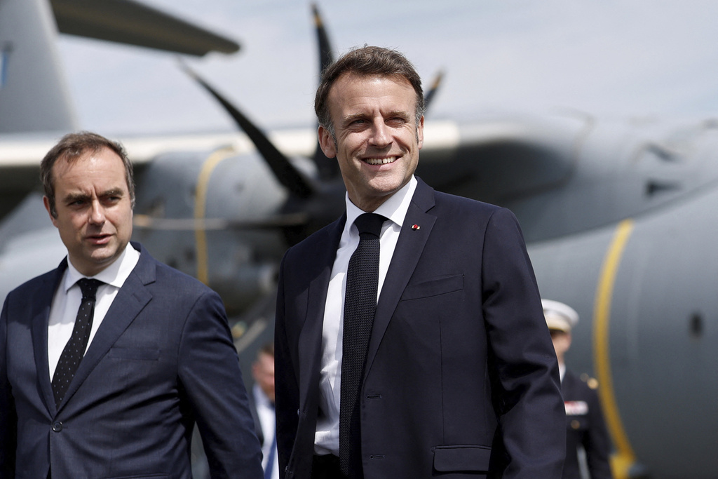 FILE - French Defense Minister Sebastien Lecornu, left, receives President Emmanuel Macron at the 55th International Paris Airshow at Le Bourget Airport near Paris, June 20, 2025. (Benoit Tessier/AP File)