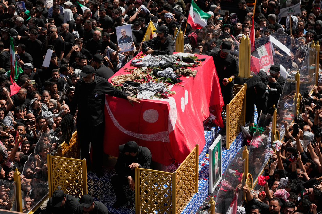 Mourners reach toward a truck carrying the coffin of Iranian Supreme Leader Ayatollah Ali Khamenei during a funeral procession in Najaf, Iraq, Wednesday, July 8, 2026. (AP Photo/Hadi Mizban)