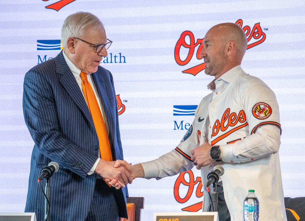 Baltimore Orioles majority owner David Rubenstein, left, congratulates the baseball club's new manager Craig Albernaz during a news conference, Tuesday, Nov. 4, 2025, in Baltimore. (Jerry Jackson/The Baltimore Banner via AP)