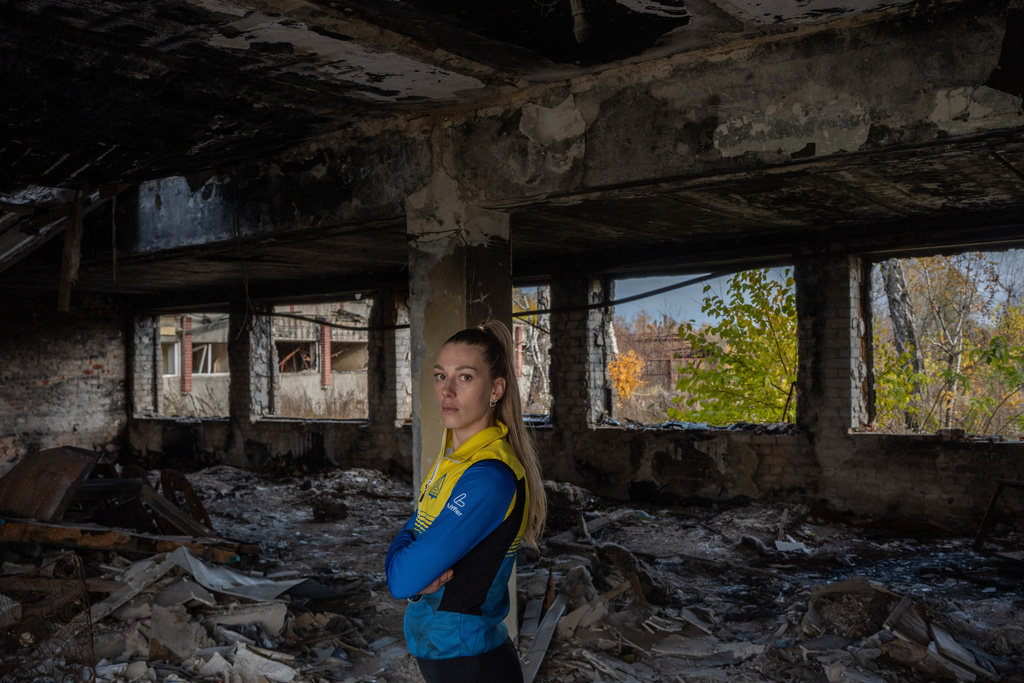 Biathlete Khrystyna Dmytrenko poses for photos inside the destroyed ski base in Chernihiv, Ukraine, Thursday, Oct. 30, 2025. (AP Photo/Julia Demaree Nikhinson)