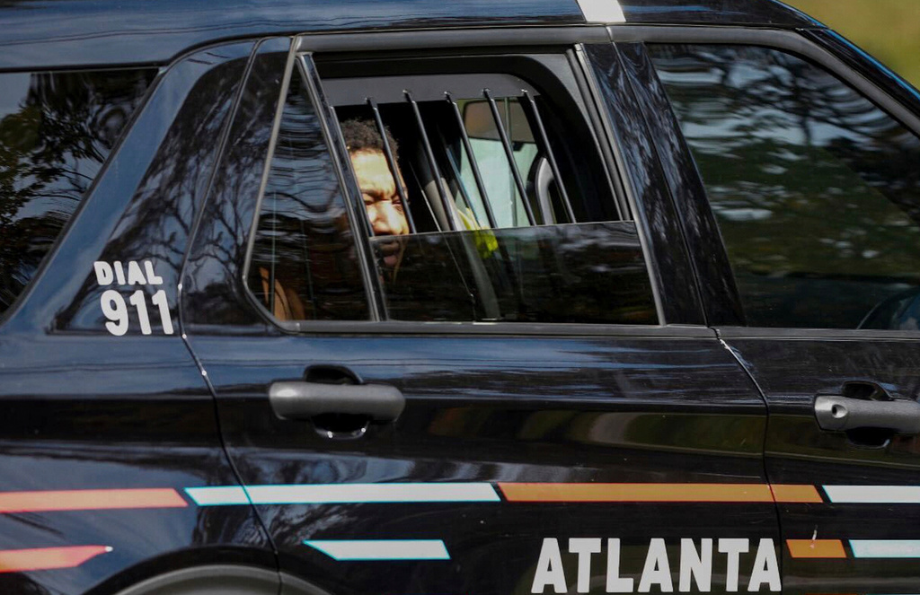 FILE - Derrick Groves sits in a police vehicle after being taken into custody by U.S. Marshals and Atlanta police at a southwest Atlanta home, Oct. 8, 2025. (Ben Hendren/Atlanta Journal-Constitution via AP, file)