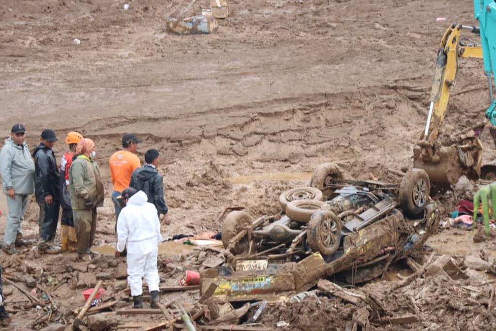 In this photo released by Indonesia's National Disaster Management Agency (BNPB) rescuers search for victims in Pasir Langu village after a landslide, in West Bandung district of West Java province, Indonesia, Monday, Jan. 26, 2026. (BNPB via AP)