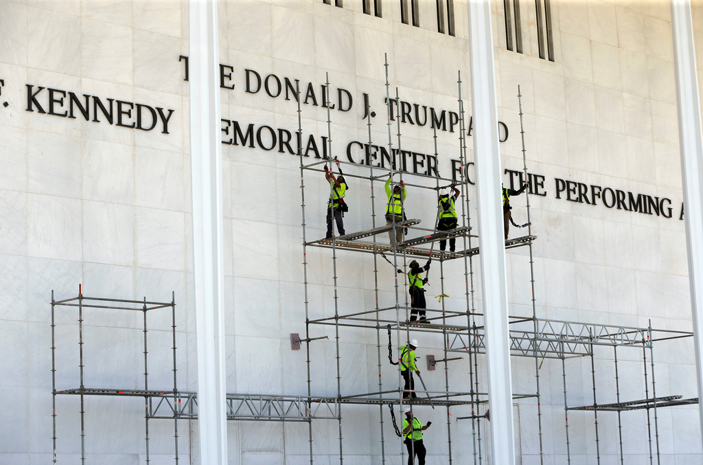 Workers construct scaffolding below the John F. Kennedy Center for the Performing Arts sign Friday, June 12, 2026, in Washington. (AP Photo/Rahmat Gul)