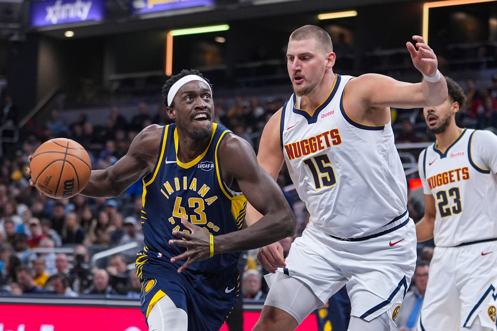 Indiana Pacers forward Pascal Siakam (43) looks to shoot over Denver Nuggets center Nikola Jokic (15) during the first half of an NBA basketball game in Indianapolis, Wednesday, Dec. 3, 2025. (AP Photo/Michael Conroy)