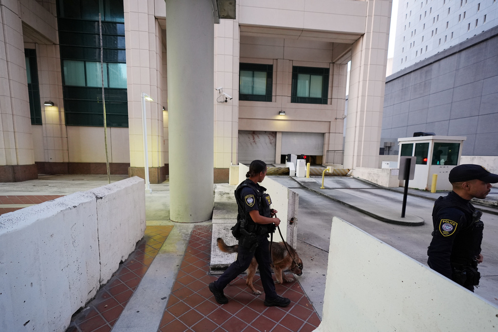 Police with a canine check outside the James Lawrence King Federal Building, where Secretary of State Marco was expected to testify in the trial of his former roommate David Rivera, Tuesday, March 24, 2026, in Miami. (AP Photo/Rebecca Blackwell)