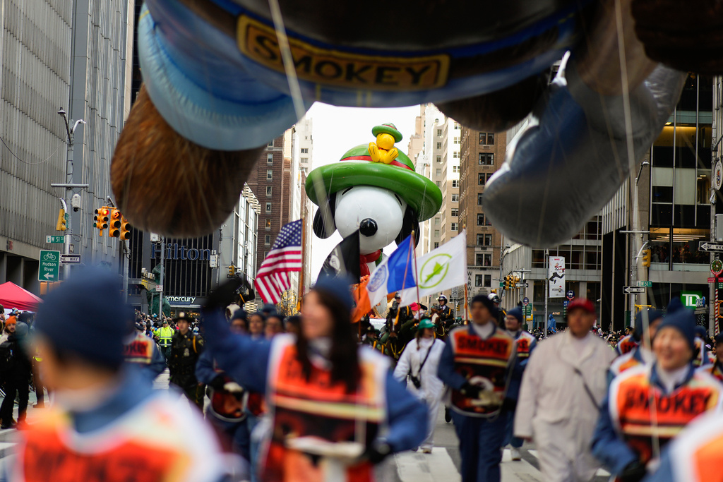 The Beagle Scout Snoopy balloon floats down Sixth Avenue led by the Smokey the Bear balloon during the Macy's Thanksgiving Day Parade, Thursday, Nov. 27, 2025, in New York. (AP Photo/Eduardo Munoz Alvarez)