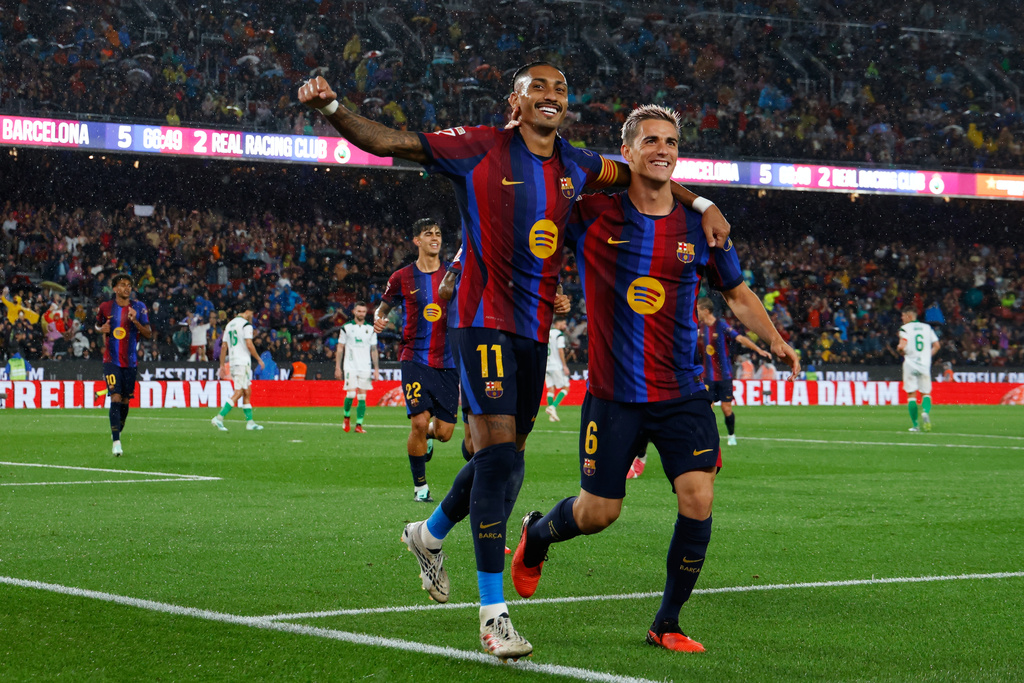Barcelona's Raphinha celebrates with Gavi, right, after scoring his side's fifth goal from the penalty spot during a Spanish La Liga soccer match between Barcelona and Racing de Santander in Barcelona, Spain, Wednesday, Sept. 16, 2026. (AP Photo/Joan Monfort)