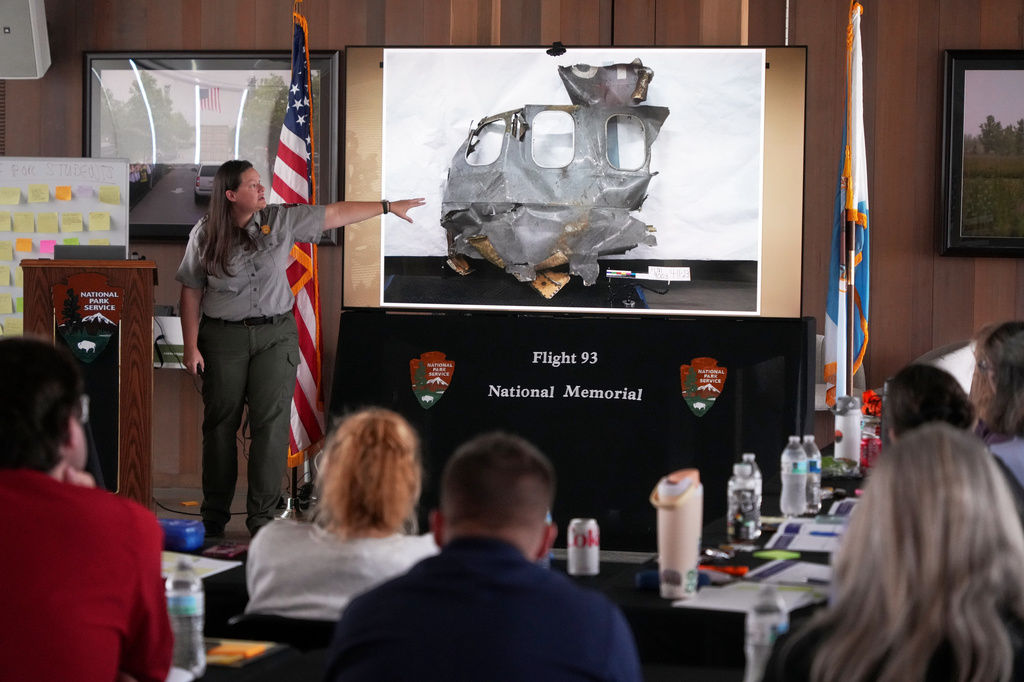 U.S. Park Ranger Betsy Keene, curator of National Parks of Western Pennsylvania, explains a slide showing a damaged part of United Flight 93 during an educators seminar at the Flight 93 National Memorial in Shanksville, Pa., Tuesday, June 23, 2026. (AP Photo/Gene J. Puskar)