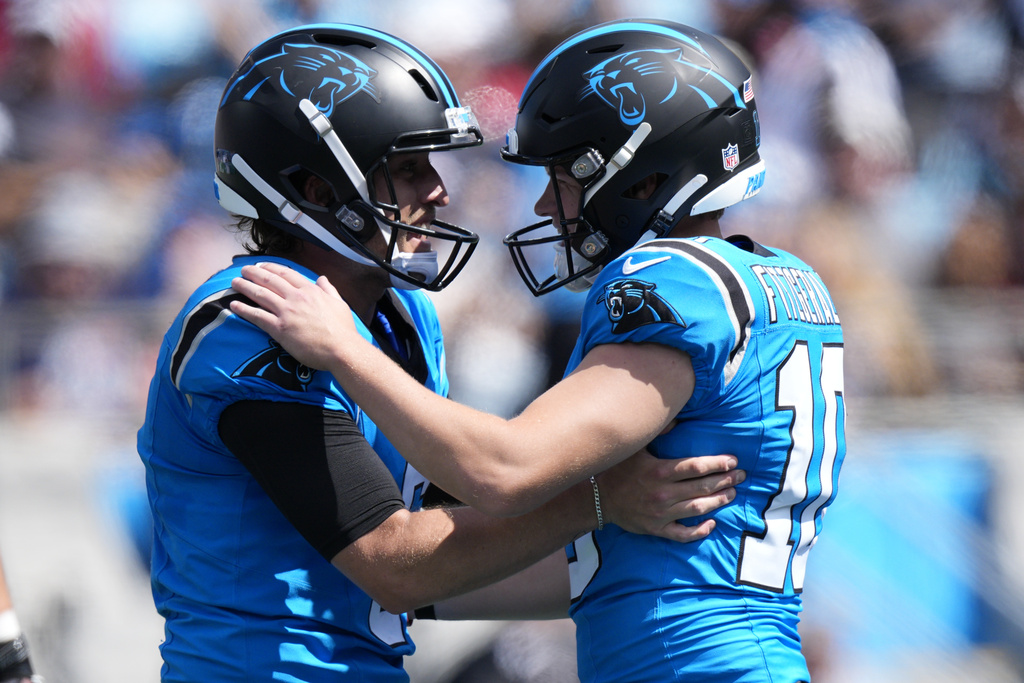 Carolina Panthers kicker Ryan Fitzgerald celebrates after kicking a field goal with Nic Scourton against the Atlanta Falcons during the first half of an NFL football game, Sunday, Sept. 21, 2025, in Charlotte, N.C. (AP Photo/Jacob Kupferman)
