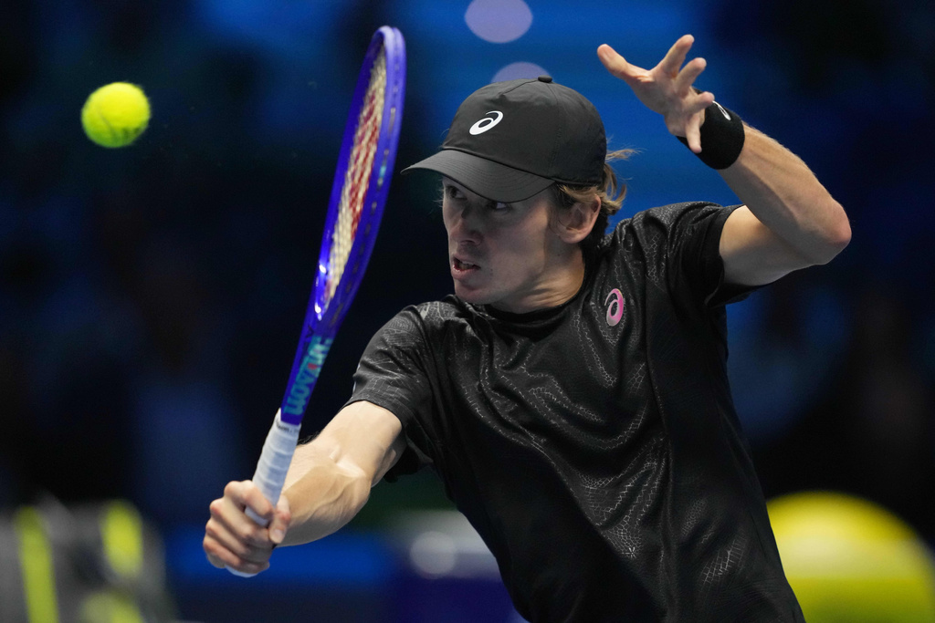 Australia's Alex de Minaur returns the ball to Spain's Carlos Alcaraz during their singles tennis match of the ATP World Tour Finals, in Turin, Italy, Sunday, Nov. 9, 2025. (AP Photo/Antonio Calanni)