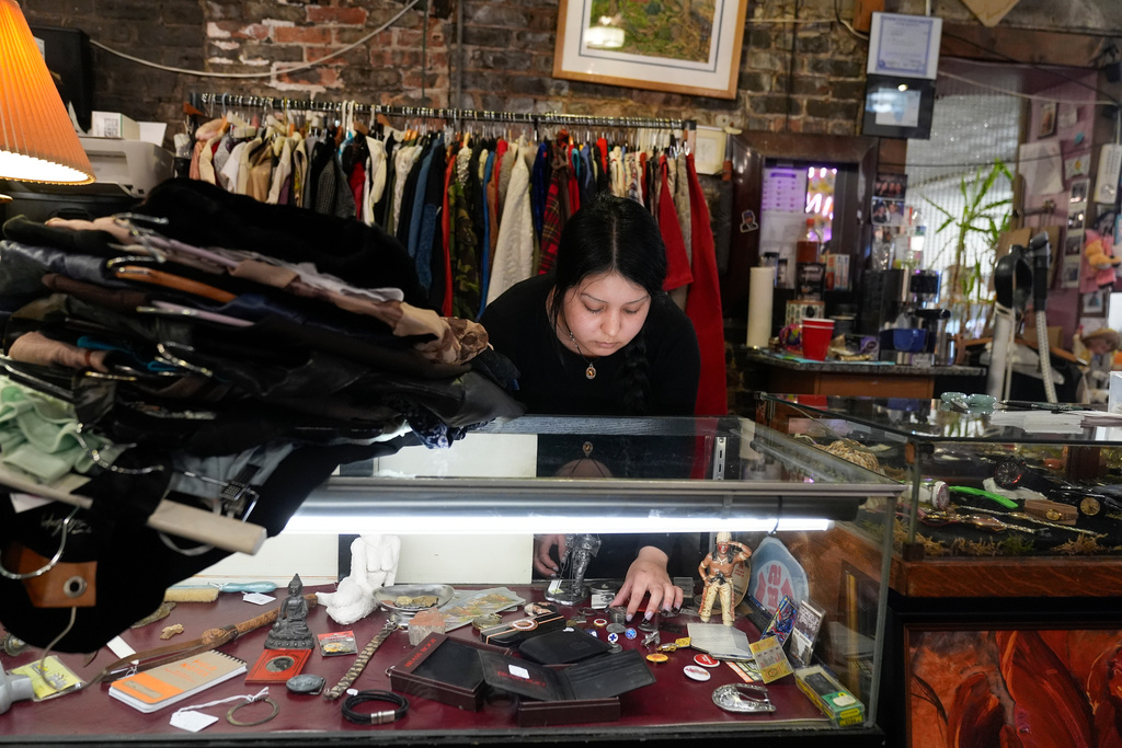 Satani Silva works at Pilsen Vintage, a vintage store, Wednesday, Nov. 19, 2025, in the Pilsen neighborhood of Chicago. (AP Photo/Erin Hooley)