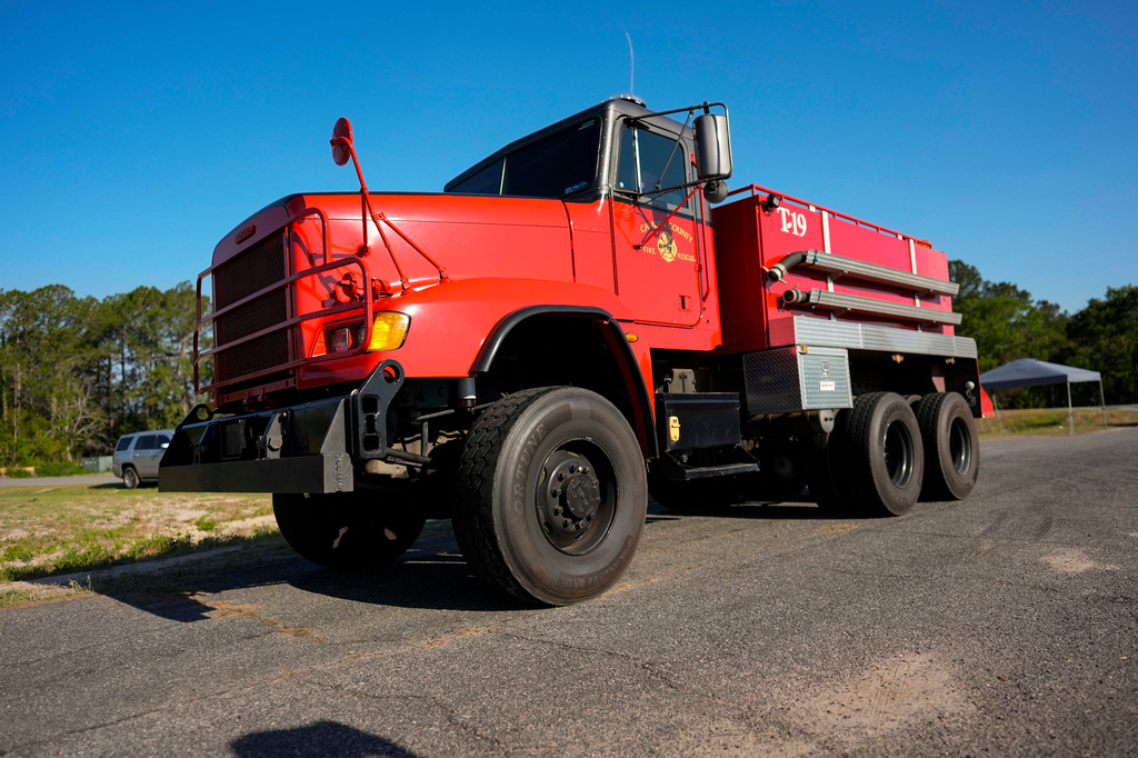 Fire crews and truck assemble at the Brantley County Airport as they work the Brantley highway 82 fire, Thursday, April 23, 2026, near Nahunta, Ga. (AP Photo/Mike Stewart)