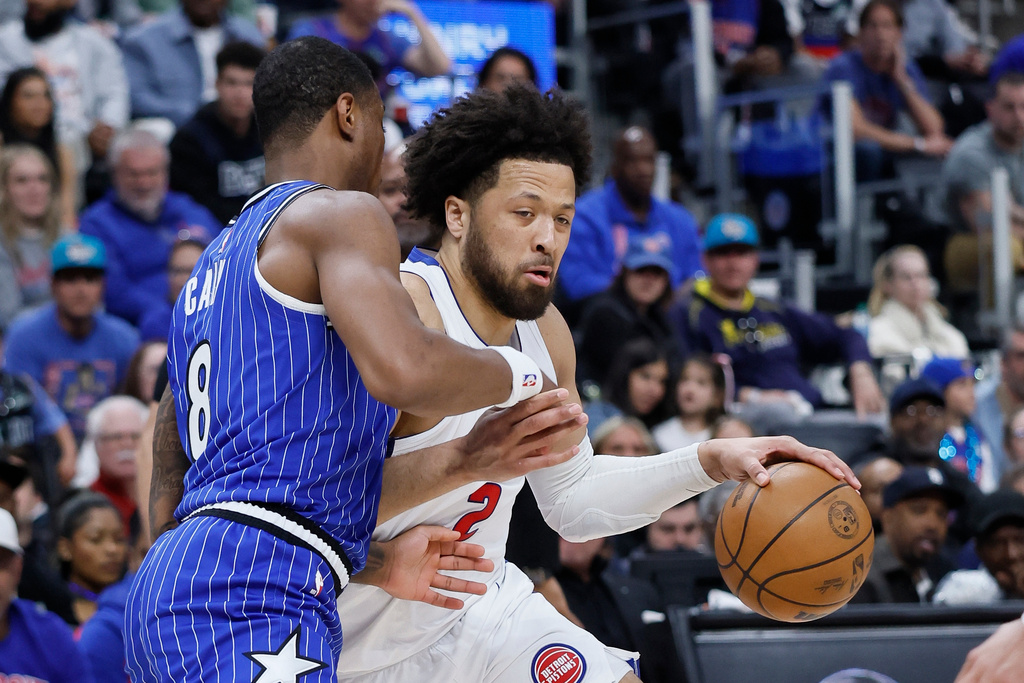 Detroit Pistons guard Cade Cunningham (2) drives against Orlando Magic forward Jamal Cain (8) during the first half in Game 7 of a first-round NBA basketball playoffs series Sunday, May 3, 2026, in Detroit. (AP Photo/Duane Burleson)
